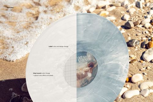 PSD mockup of a vinyl record featuring a half-and-half color effect, lying on sandy beach with small stones and waves.