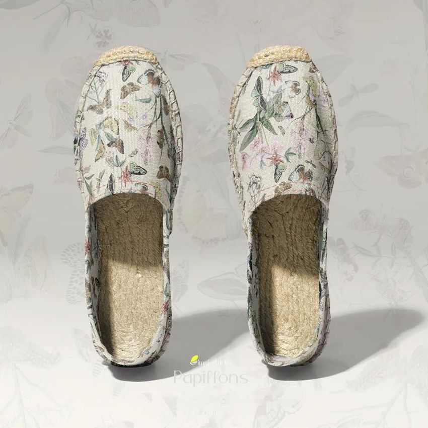 Canvas espadrilles mockup featuring a pair of shoes with a butterfly and floral pattern, viewed from above on a light background.