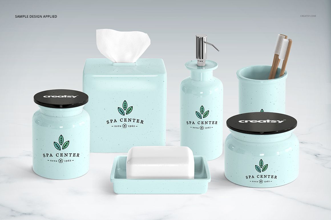 Collection of pastel blue bathroom items with pump bottle, soap dish, and jars displayed on a white surface, PSD mockup.