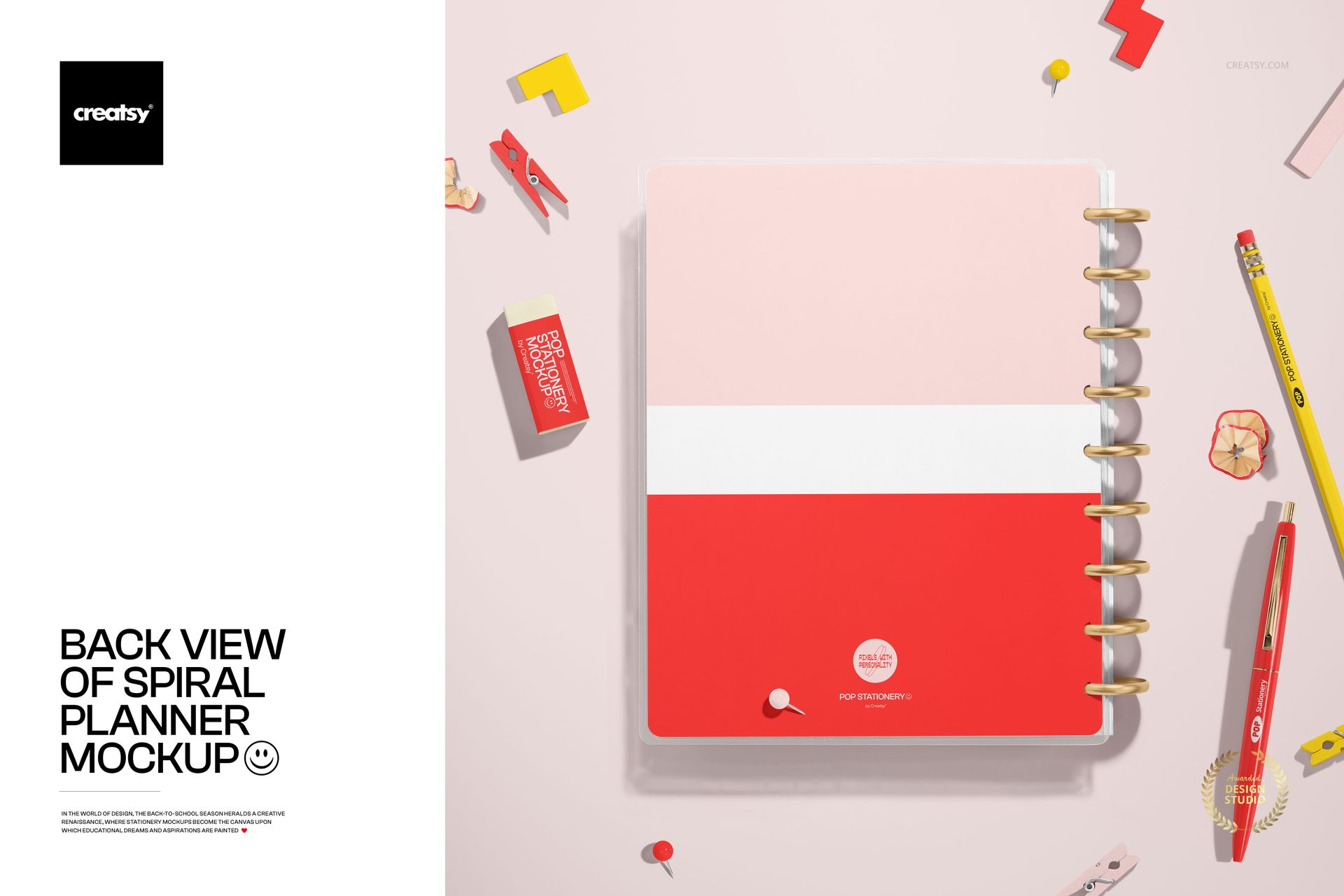 Spiral-bound planner mockup shown from above, featuring a two-tone pink and red cover and assorted desk accessories.