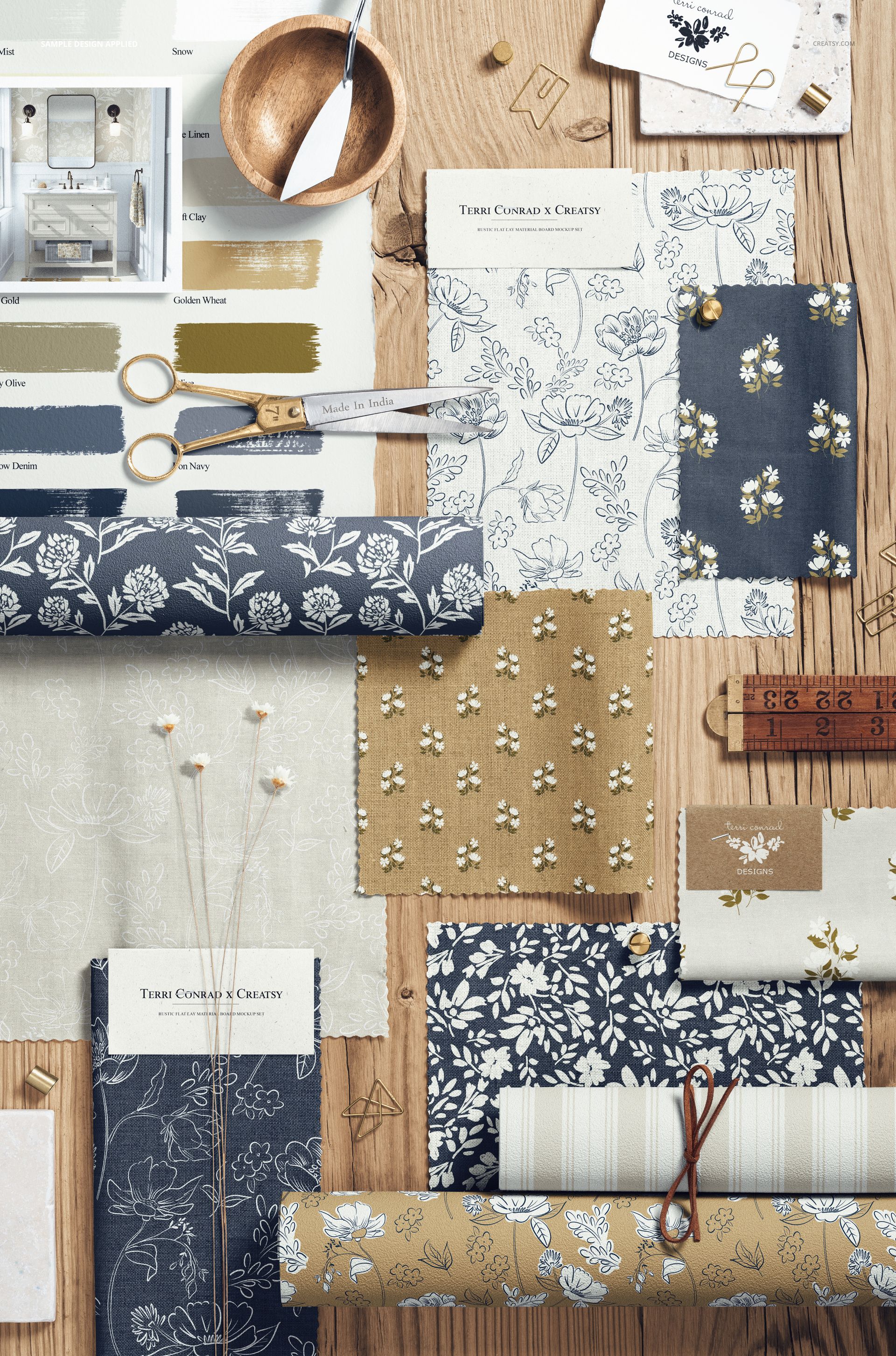 Top view of a rustic moodboard mockup with various fabric swatches in blue, beige, and white floral patterns on wood.