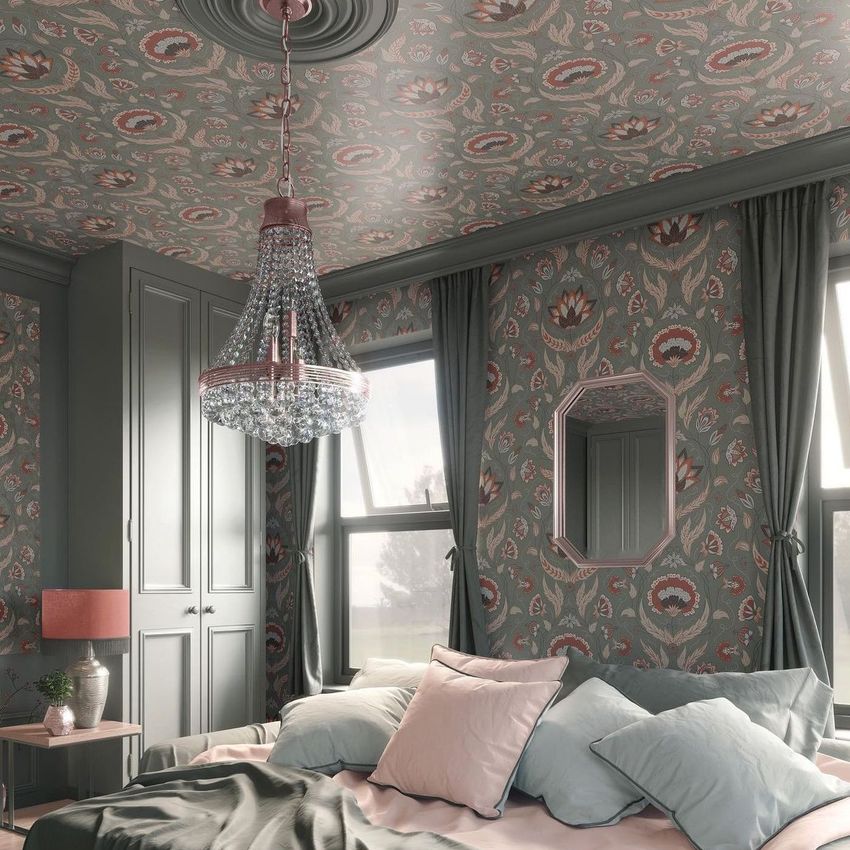 Bedroom mockup featuring floral patterned wallpaper and bedding in muted green and pink tones, with a chandelier and large windows.
