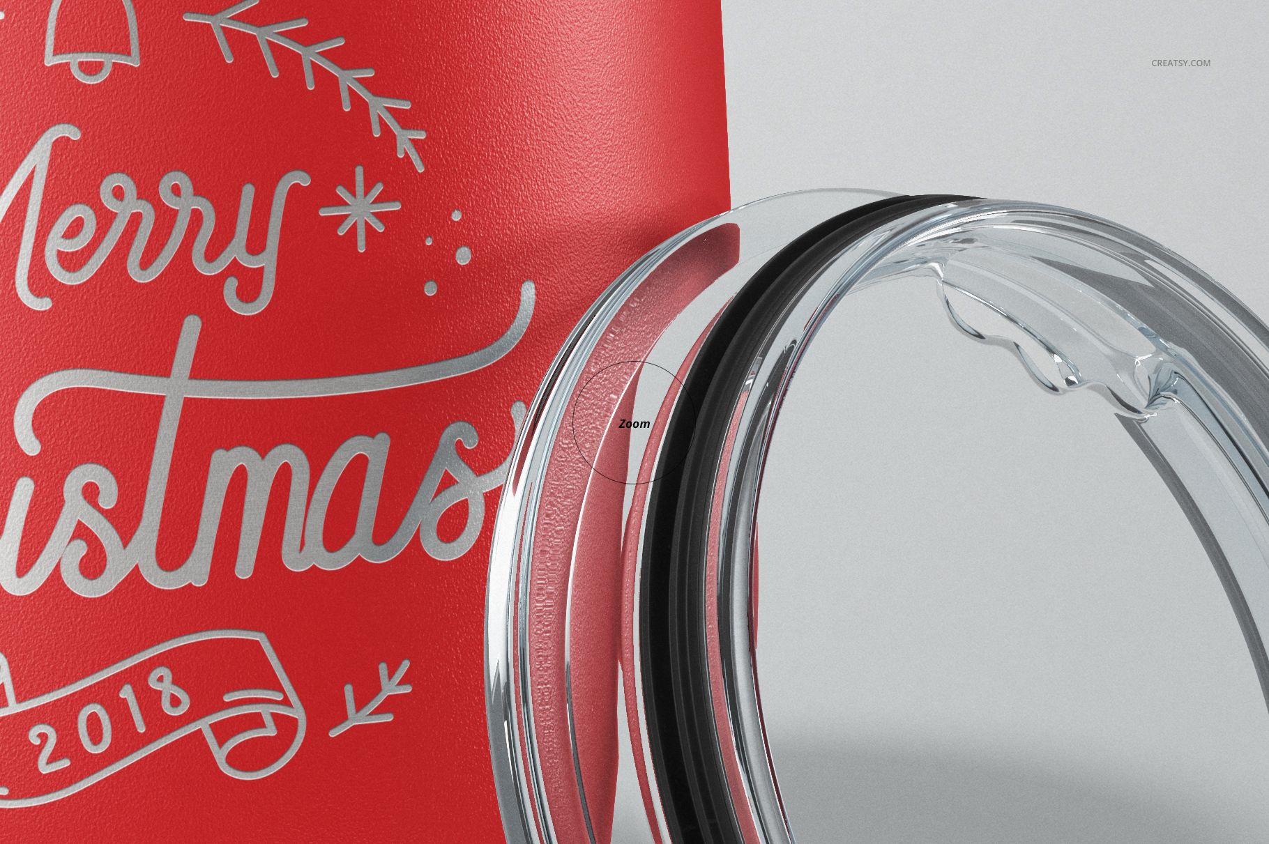 Close-up of a red stemless wine cup with white festive lettering, shown next to a transparent plastic lid on a light background.