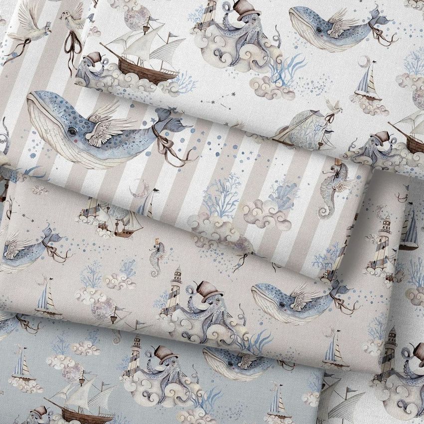 Folded fabrics mockup showing stacked fabric pieces with nautical and ocean-themed illustrations in soft pastel colors.