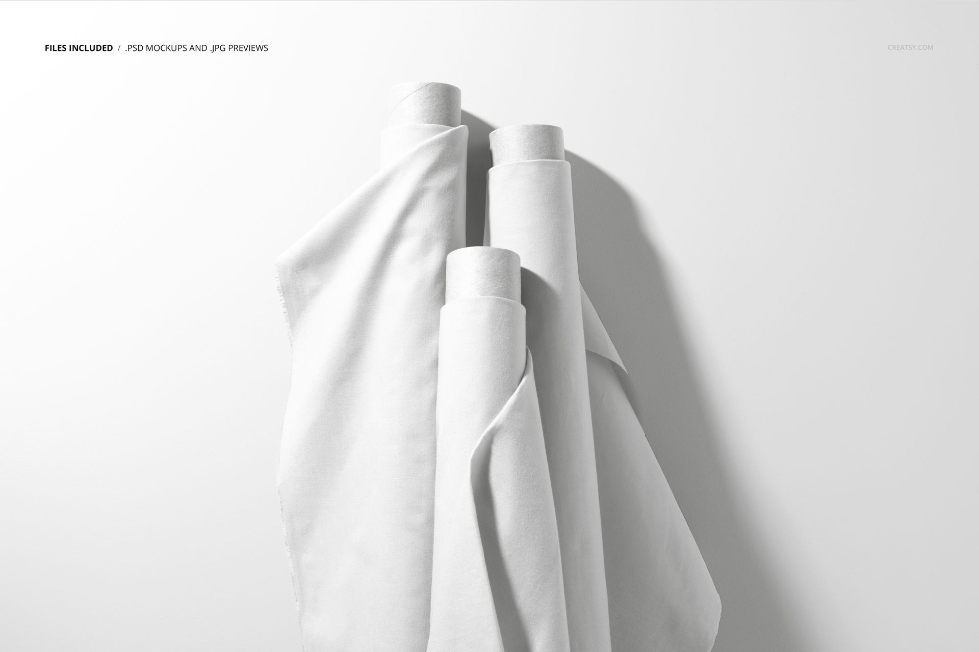 Vertical arrangement of three fabric rolls in white, with soft folds and shadows, shown in a realistic mockup scene.
