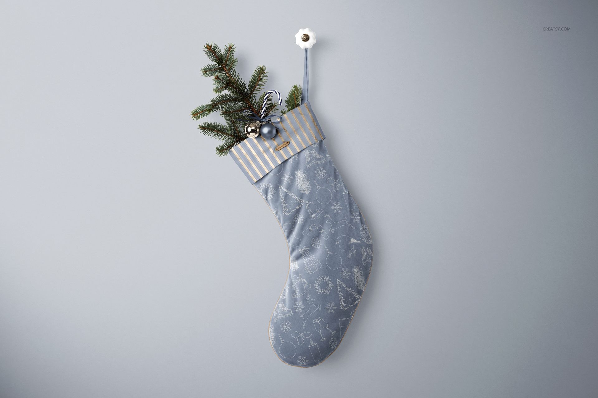 Velvet Christmas stocking mockup featuring a blue stocking with holiday motifs, pine sprig, and ornaments inside.