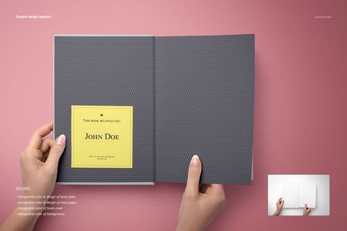 Open bookplate mockup showing a gray dotted hardcover book on a pink surface, held by two hands, with a yellow label inside.