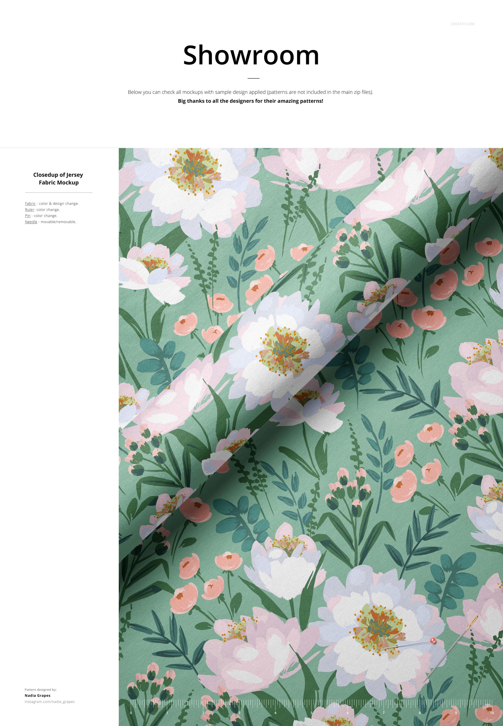 Folded jersey fabric mockup featuring a botanical design with large white flowers and green leaves on a flat surface.