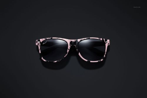 PSD mockup of fashion sunglasses featuring a glossy frame with abstract pink and black design, centered on a black surface.