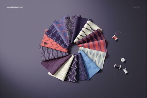 Folded fabric swatches arranged in a circular pattern on a purple surface, featuring wave patterns in blue, purple, and red tones.