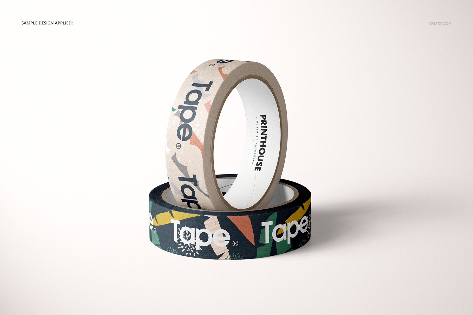 Mockup of paper packing tape rolls, one in beige and one in black, both with graphic patterns, shown in a minimalist scene.