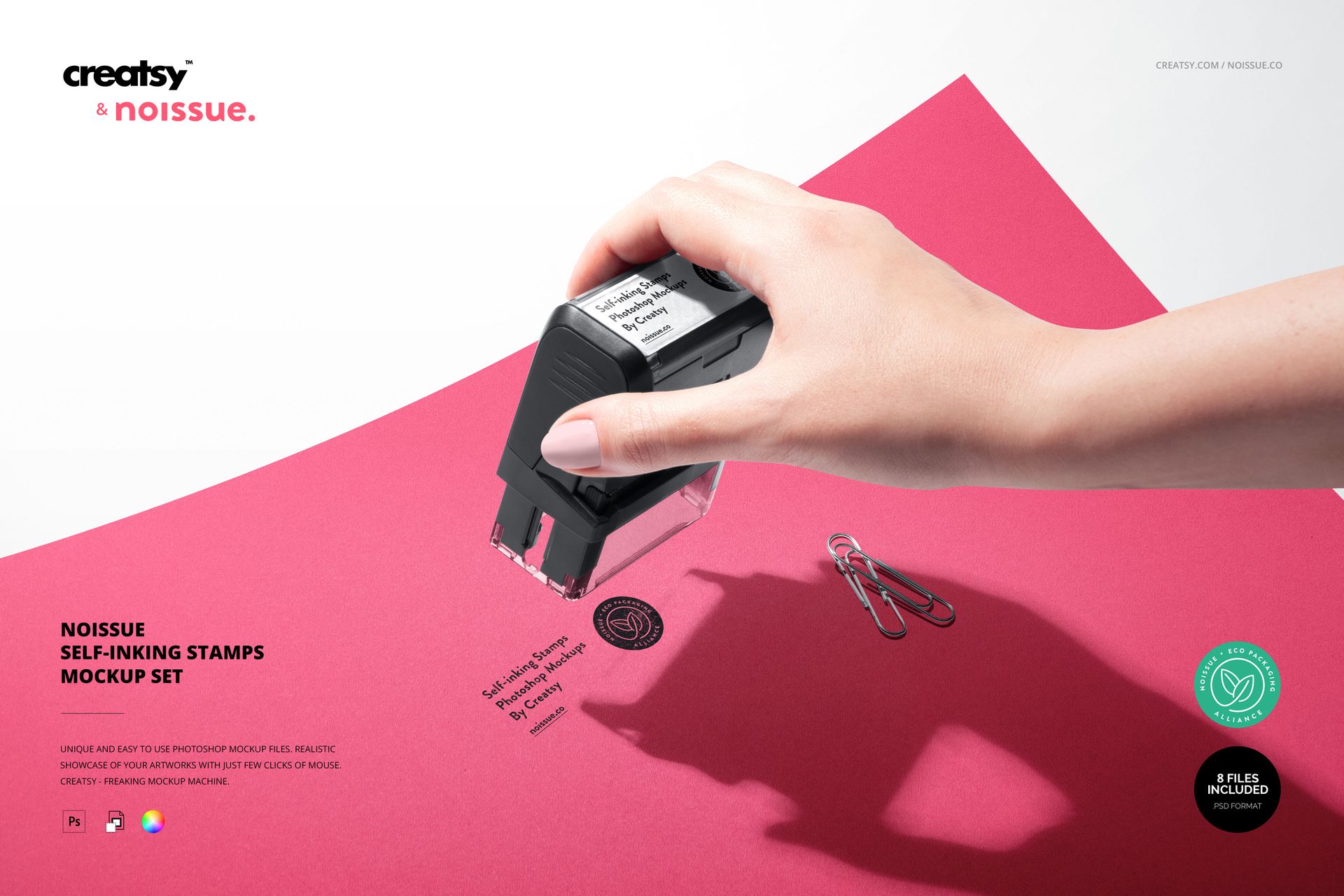 Mockup scene showing a black self-inking stamp applied to red paper, with a stamped design and office supplies.