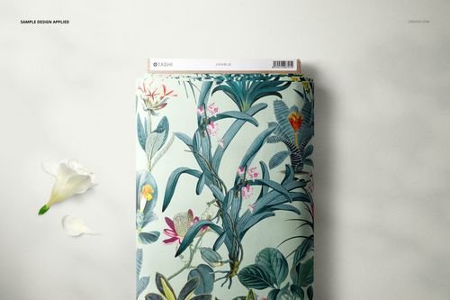 Fabric bolt mockup featuring a botanical design with green leaves and colorful flowers, shown from above with a cardboard edge.