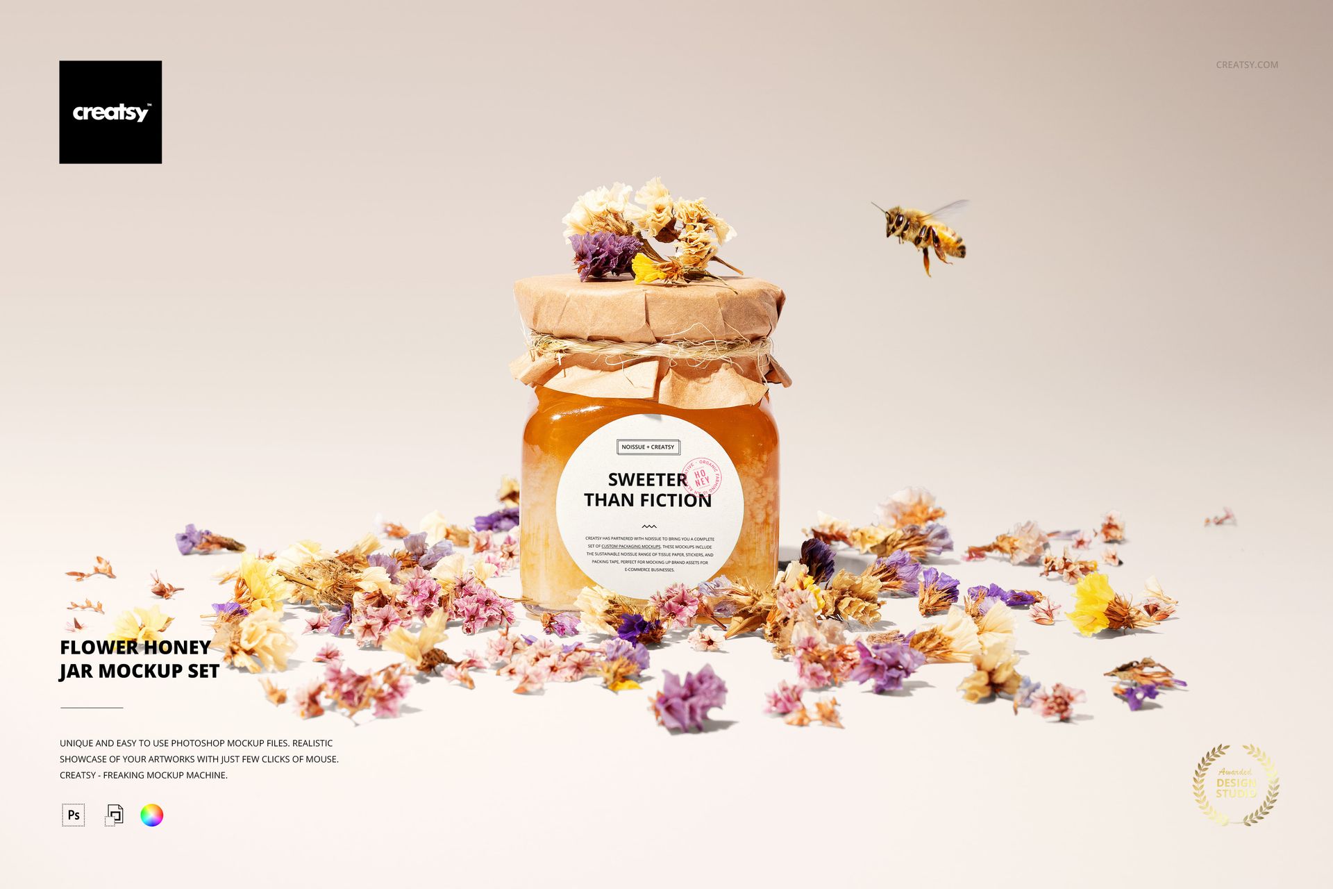 Front view of a honey jar mockup with a kraft paper lid, floral label, and assorted dried flowers on a light background.