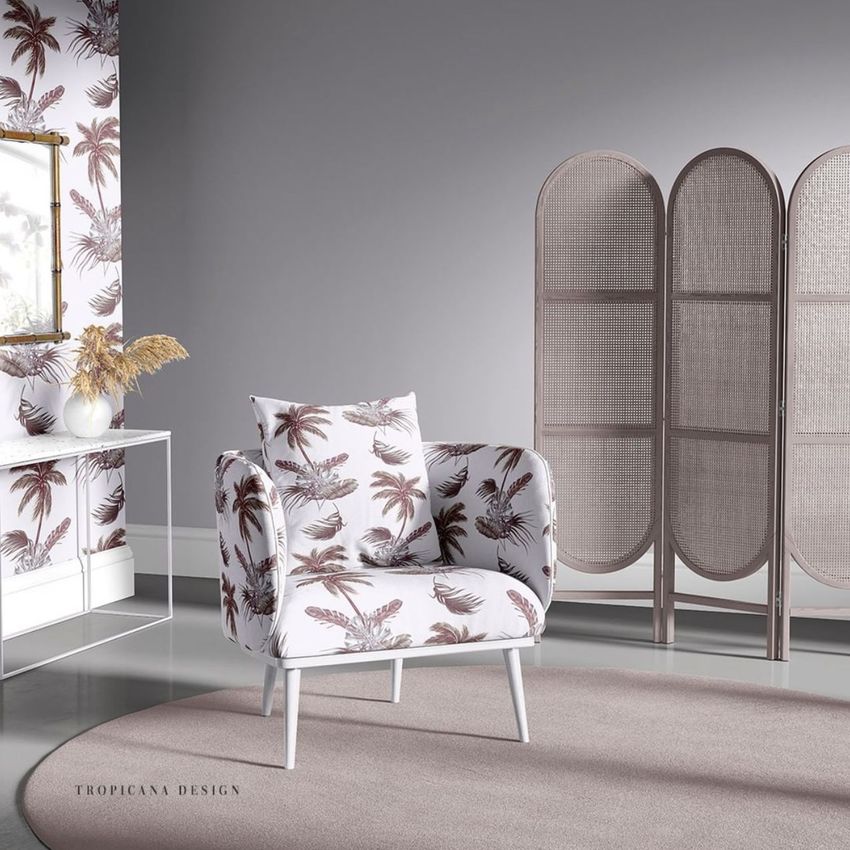 Armchair mockup in a sitting corner with palm tree pattern upholstery, neutral tones, and a woven room divider in the background.