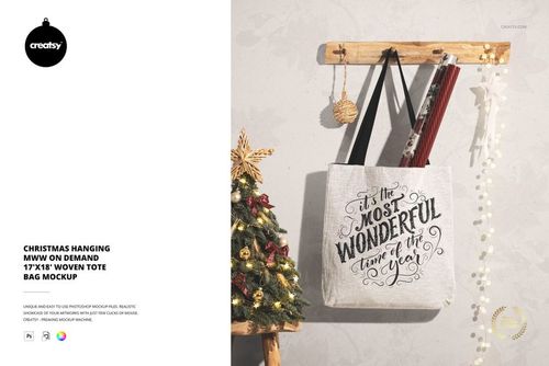 Christmas woven tote bag mockup displayed on a wall hook, with ornaments and a festive tree in the background.