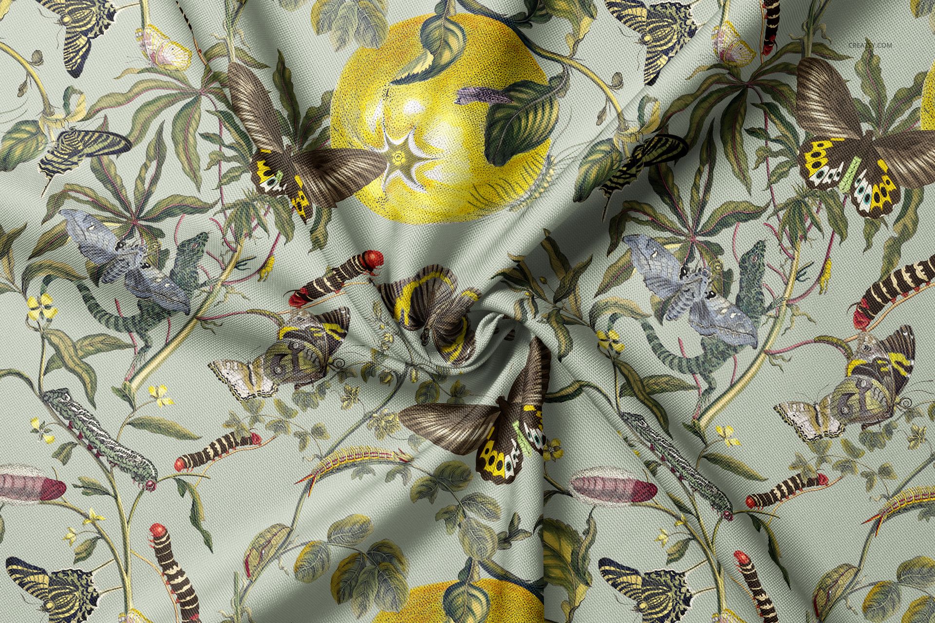 Polyester drapery fabric mockup with a botanical pattern featuring butterflies, caterpillars, and yellow fruit, viewed close-up.