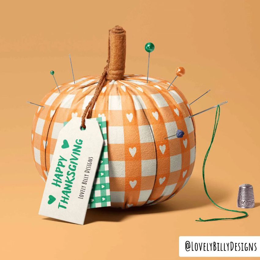 Fabric pumpkin mockup with orange and white checkered pattern, heart motifs, sewing pins, and a tag reading Happy Thanksgiving.
