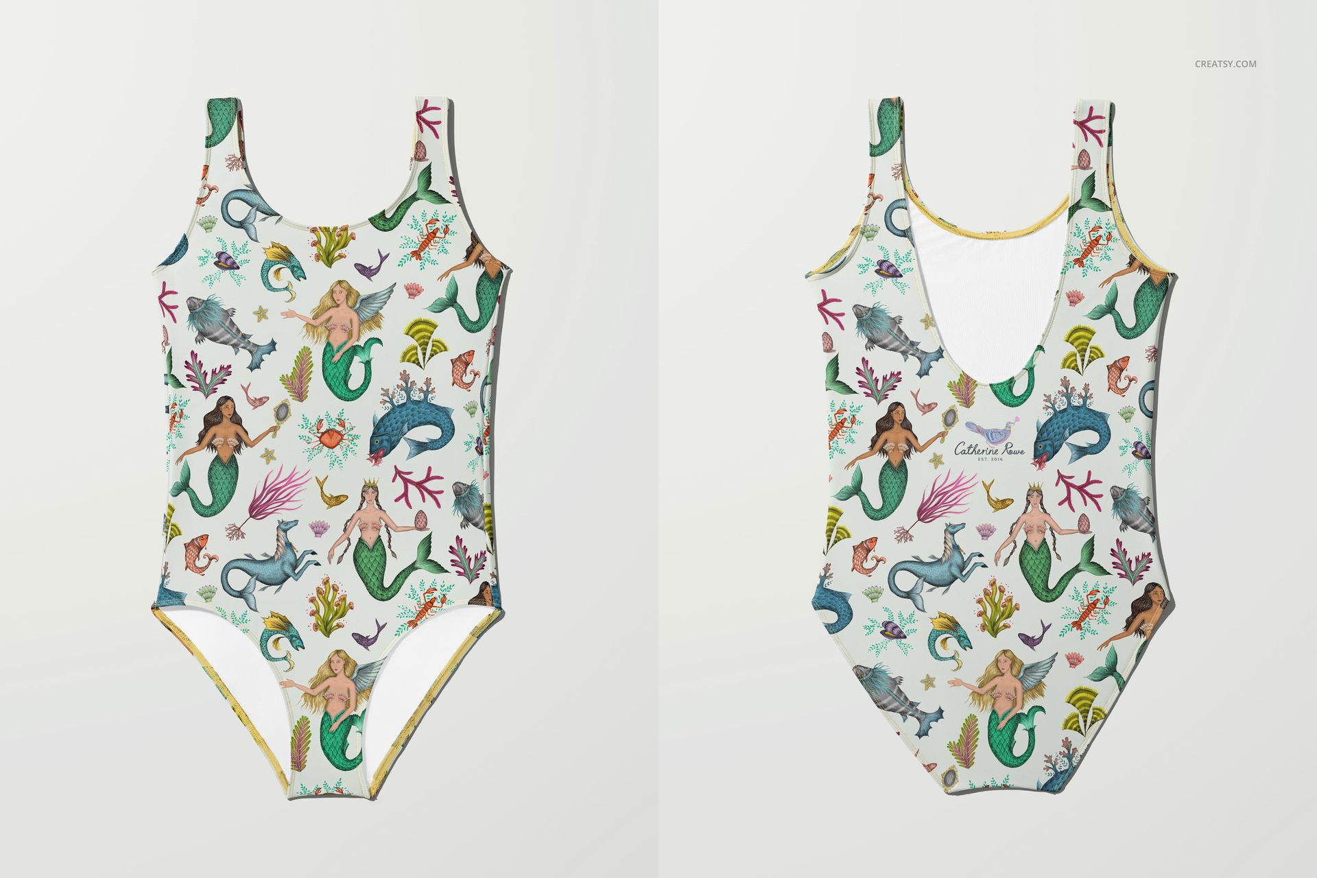 PSD mockup showing a flat-lay of a swimsuit featuring whimsical mermaids, fish, and coral in vibrant tones.