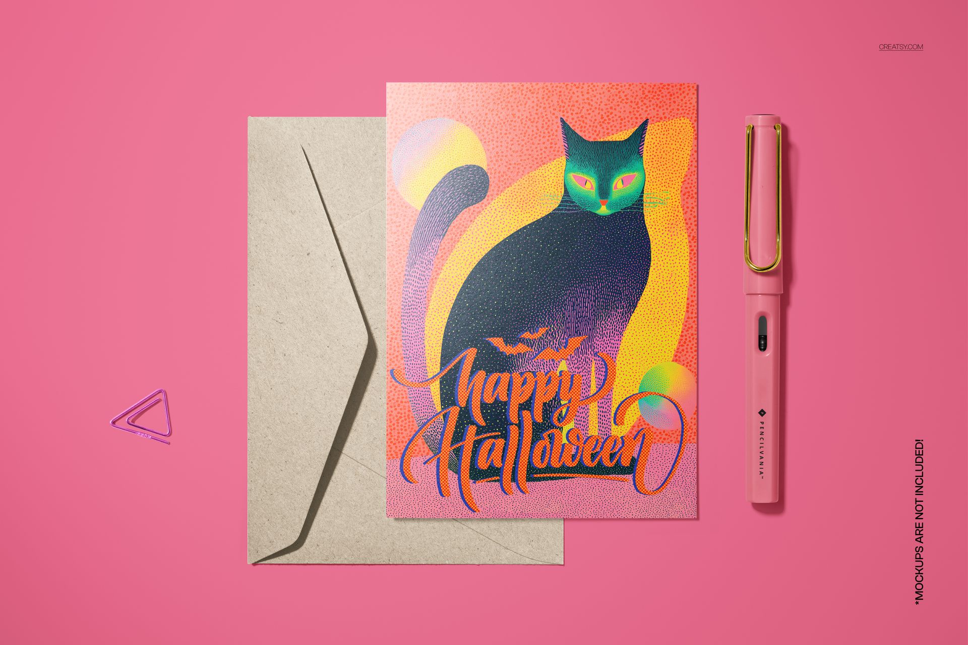 Halloween-themed 5x7 card mockup with a colorful black cat illustration, envelope, and pen on a pink background.