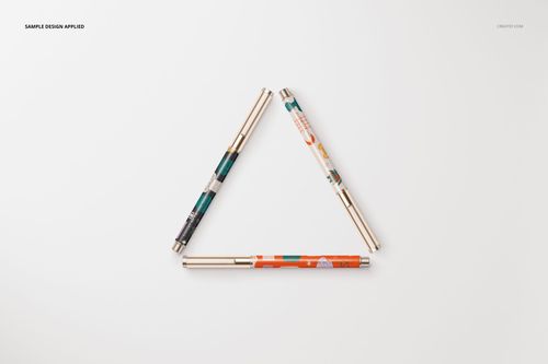 Stationery set mockup featuring three patterned pens forming a triangle shape on a plain white surface, top view.