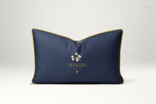Front view of a reversible cushion mockup featuring dark blue cover, yellow trim, and centered floral artwork.