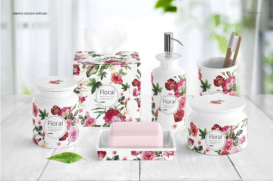 Front view of bath accessories mockup featuring porcelain containers and soap dish, decorated with pink and red floral designs.