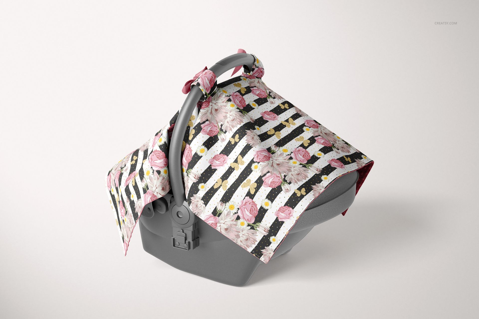 Mockup of a baby car seat with a minky canopy cover featuring pink roses and black striped design, front perspective.
