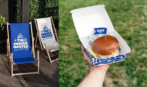 Vegan burger bar PSD mockup showing a burger in a branded box and two blue deck chairs with printed graphics.