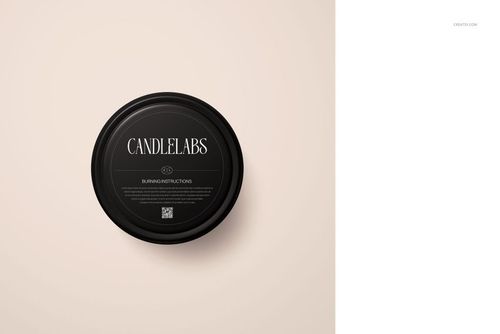 Top view of a black satin finish candle tin mockup with printed label, placed on a soft neutral surface.