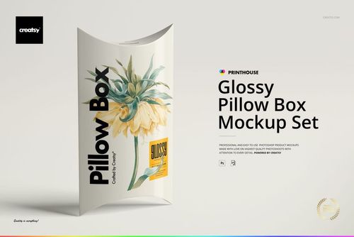 PSD mockup of a glossy pillow box featuring yellow flower illustration, shown from the front on a neutral surface.