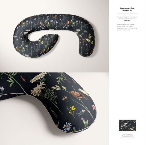 PSD mockup of a U-shaped pregnancy pillow with a black background and colorful floral and bird print, top perspective.
