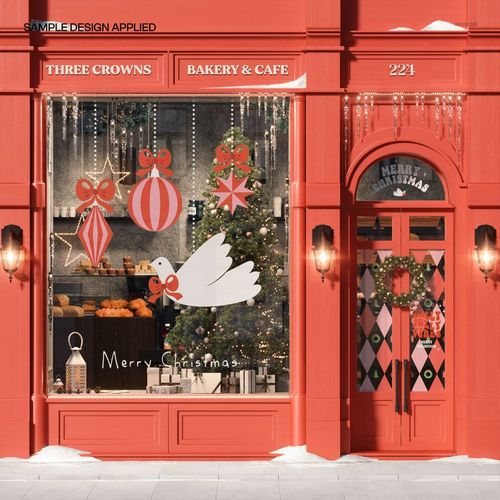 Front view of a festive bakery storefront mockup with red facade, Christmas tree, hanging ornaments, and holiday decorations.