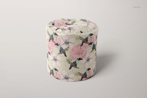 Cylinder-shaped bean bag featuring pink flowers and blue hummingbirds, displayed in a PSD mockup on a neutral surface.