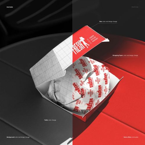 Open burger box mockup on a table, displaying a wrapped burger inside with grid and red text design elements.