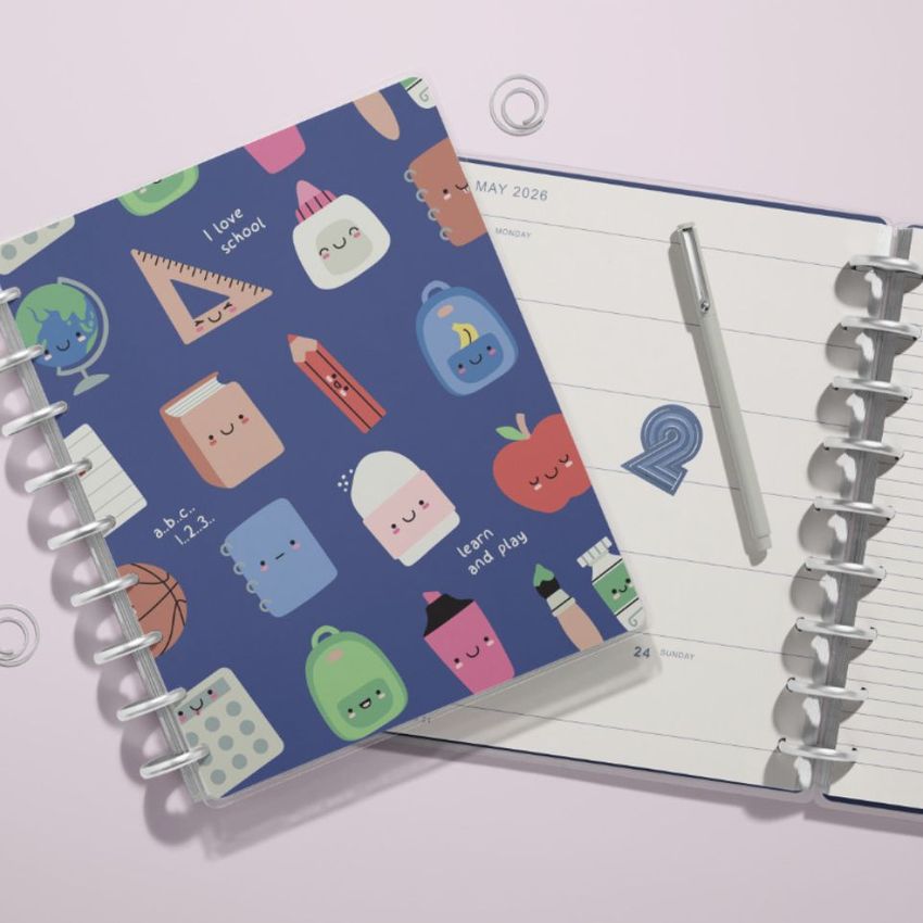 Two spiral-bound planner mockups seen from above, featuring one with playful school-themed illustrations and one open with a pen.