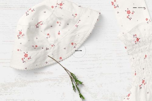 Baby summer set mockup featuring a white bucket hat and matching garment with pink floral pattern, top view.