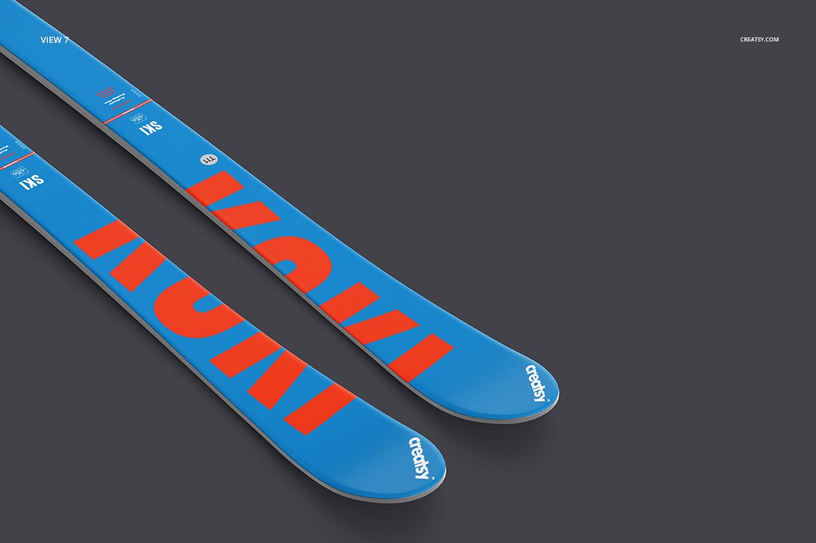 Blue skis with large red letters shown in a PSD mockup, positioned diagonally on a neutral background.