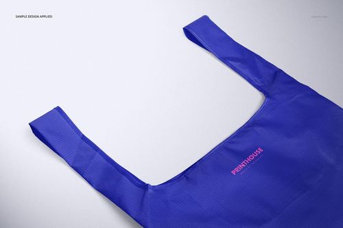 Blue ripstop reusable bag mockup displayed flat with handles extended, photographed from above on a neutral surface.