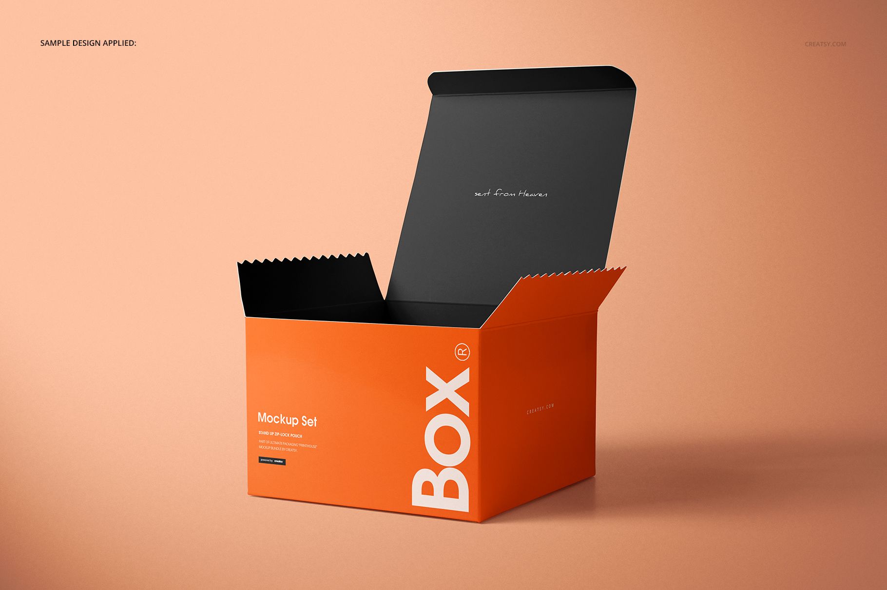 Orange chipboard gift box mockup with open black lid, jagged top edge, and minimal text, displayed on peach background.