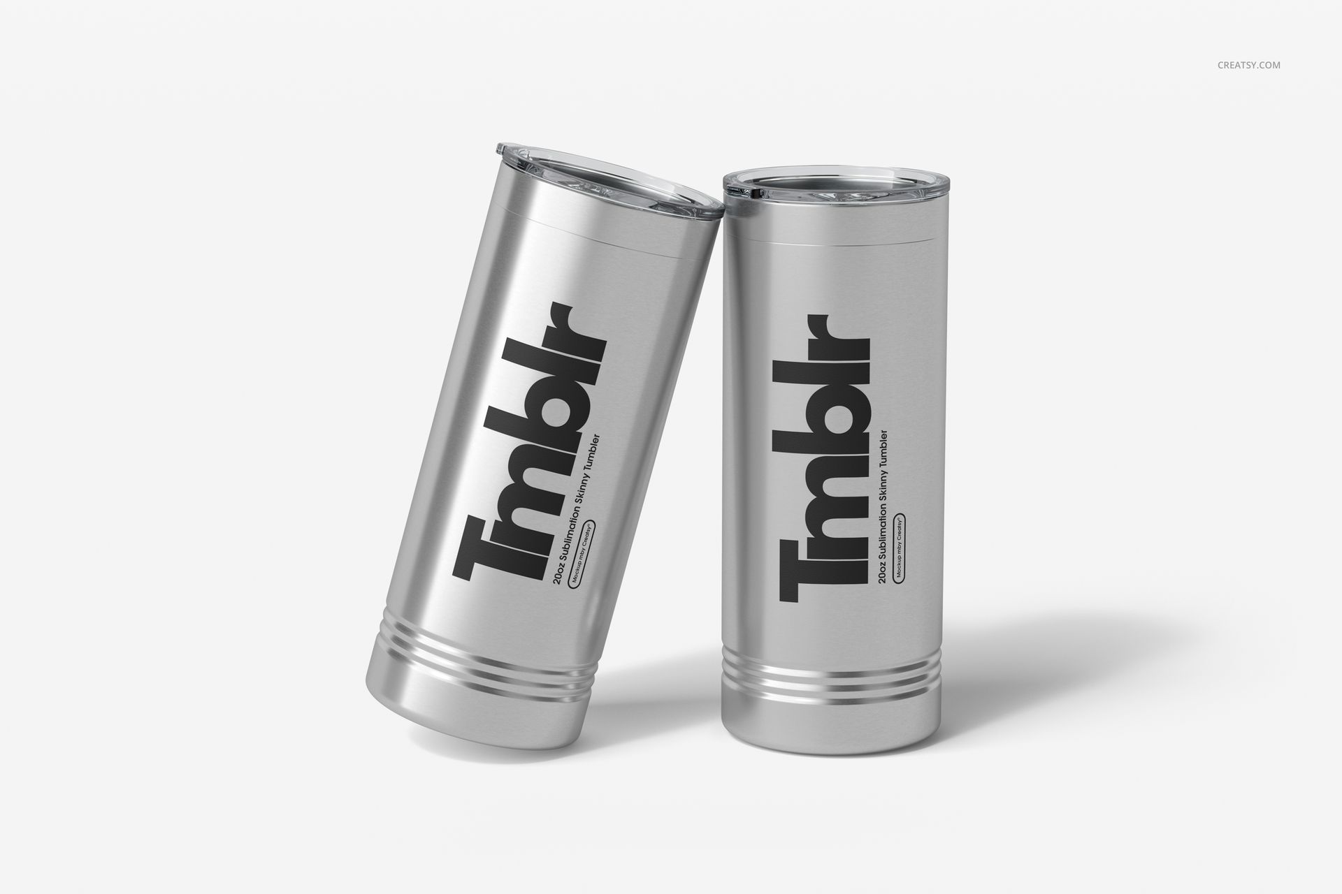 Stainless steel tumblers for engraving, featuring mockup artwork, positioned side by side with clear lids.