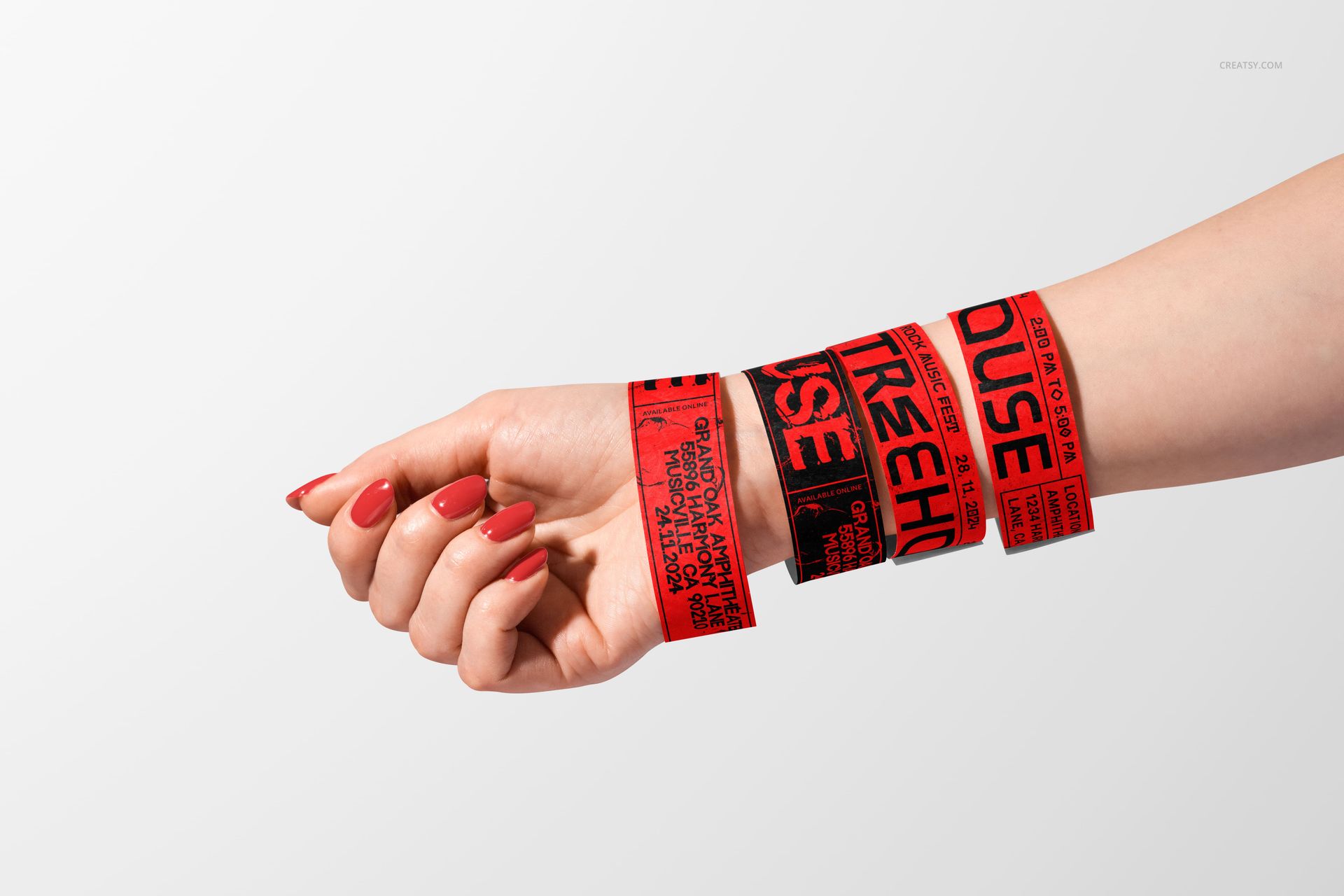 PSD mockup of a hand adorned with multiple red wristbands, each printed with black text, on a plain surface.