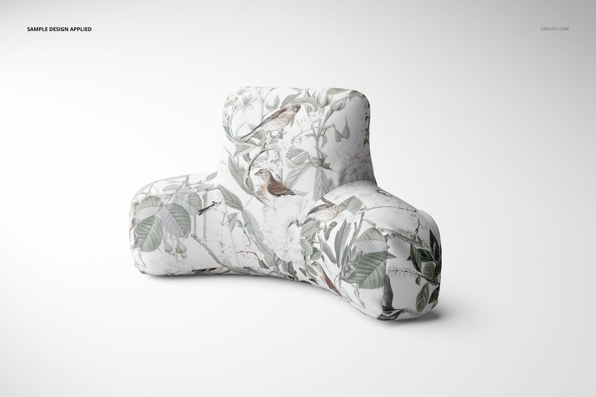 PSD mockup of a reading pillow featuring a soft floral and bird design, displayed on a plain light backdrop.