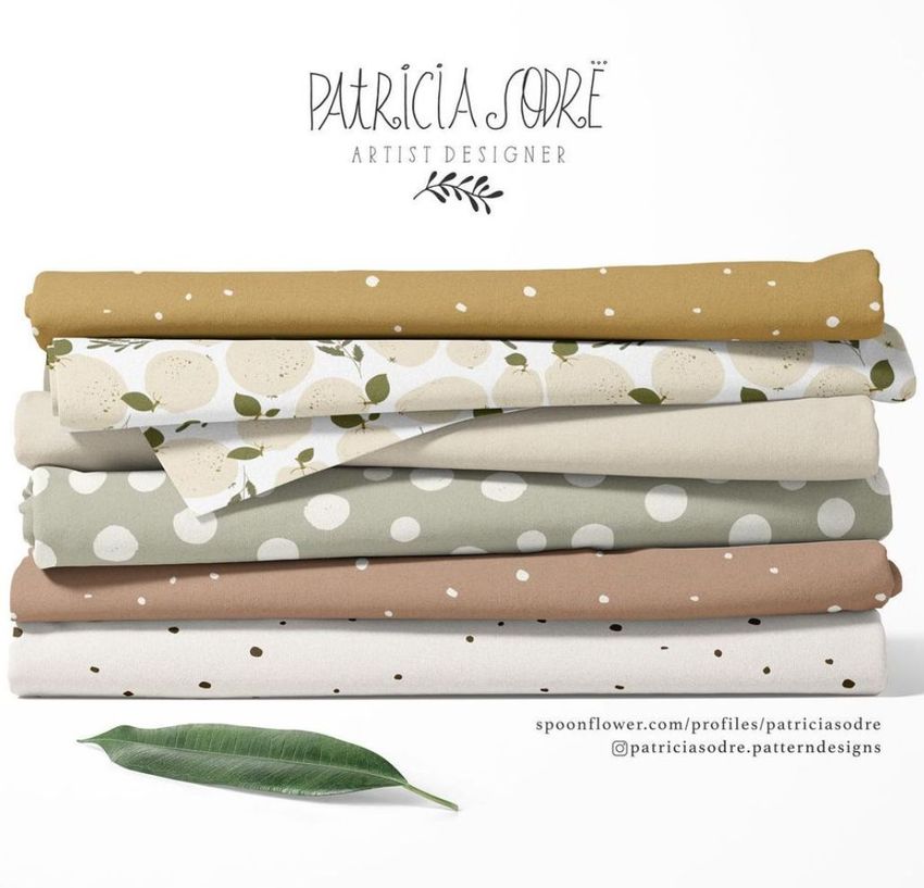 Fabric stack mockup featuring six folded fabrics with various patterns, including polka dots and abstract shapes, on a white background.