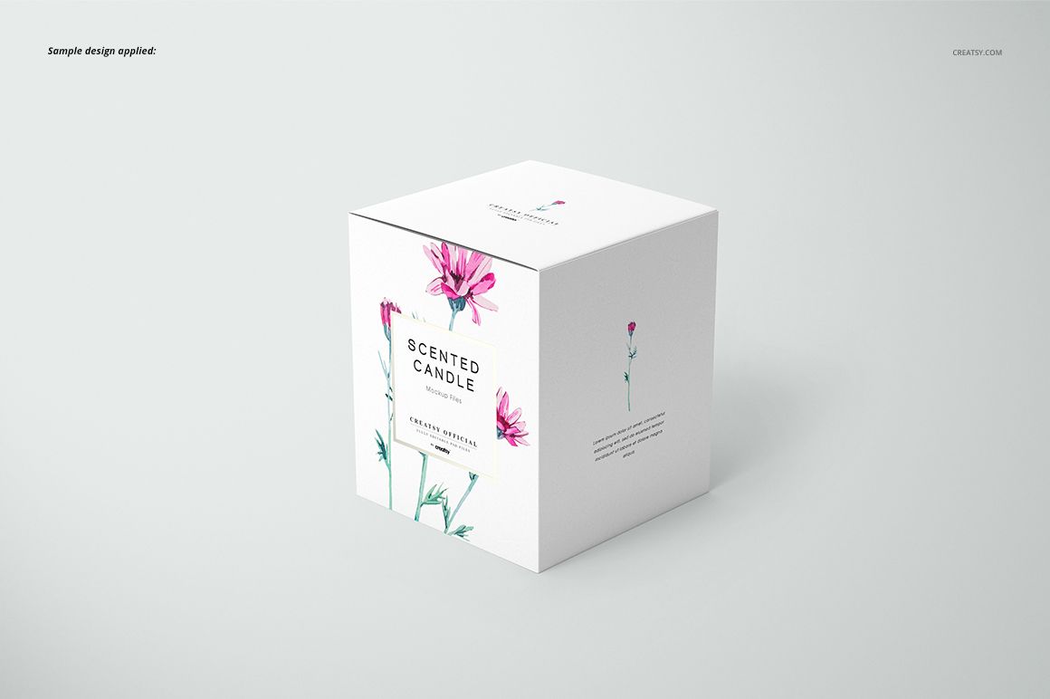 Classic candle mockup featuring a white box with delicate pink flower artwork, shown from a three-quarter perspective.