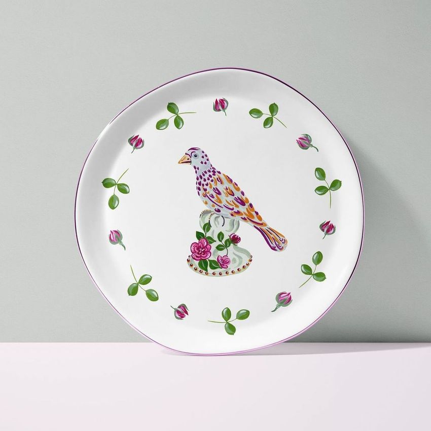 Plate mockup featuring a white porcelain plate with a colorful bird illustration and floral accents, set against a pastel background.