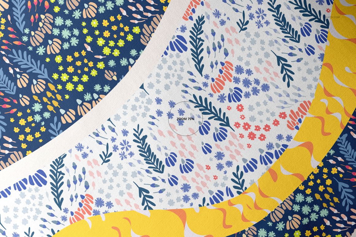 Top view of a throw pillow mockup featuring curved fabric sections with floral and leaf patterns in blue, yellow, and pink.