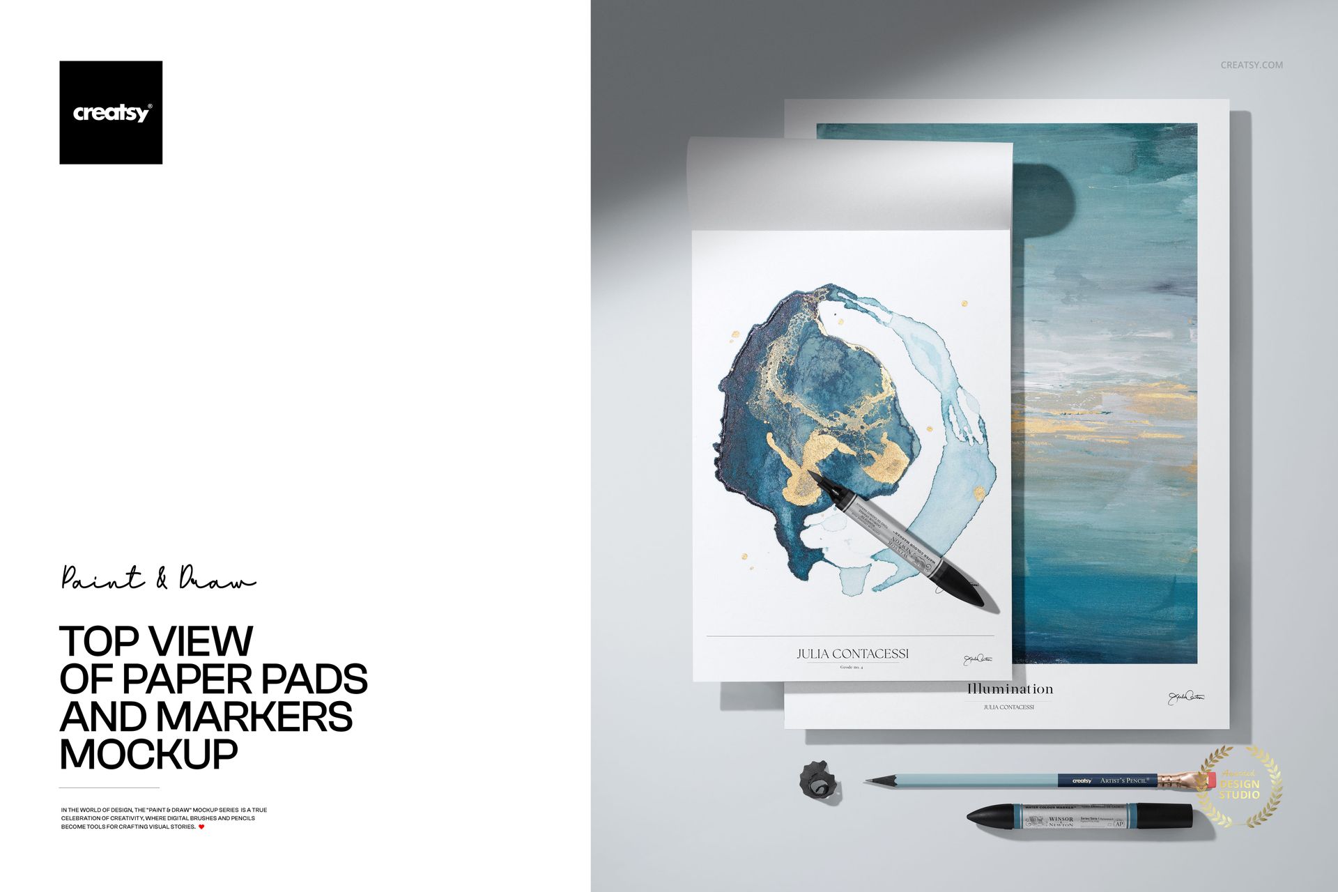 PSD mockup showing two paper pads with colorful abstract art and markers arranged on a flat tabletop.