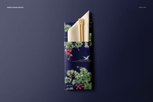 Mockup showing chopsticks and napkin in a sleeve featuring a nature-inspired pattern, set against a solid dark backdrop.