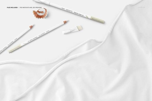 Jersey fabric mockup in white, shown with marking pencils, a pencil shaving, and brush on a light background.